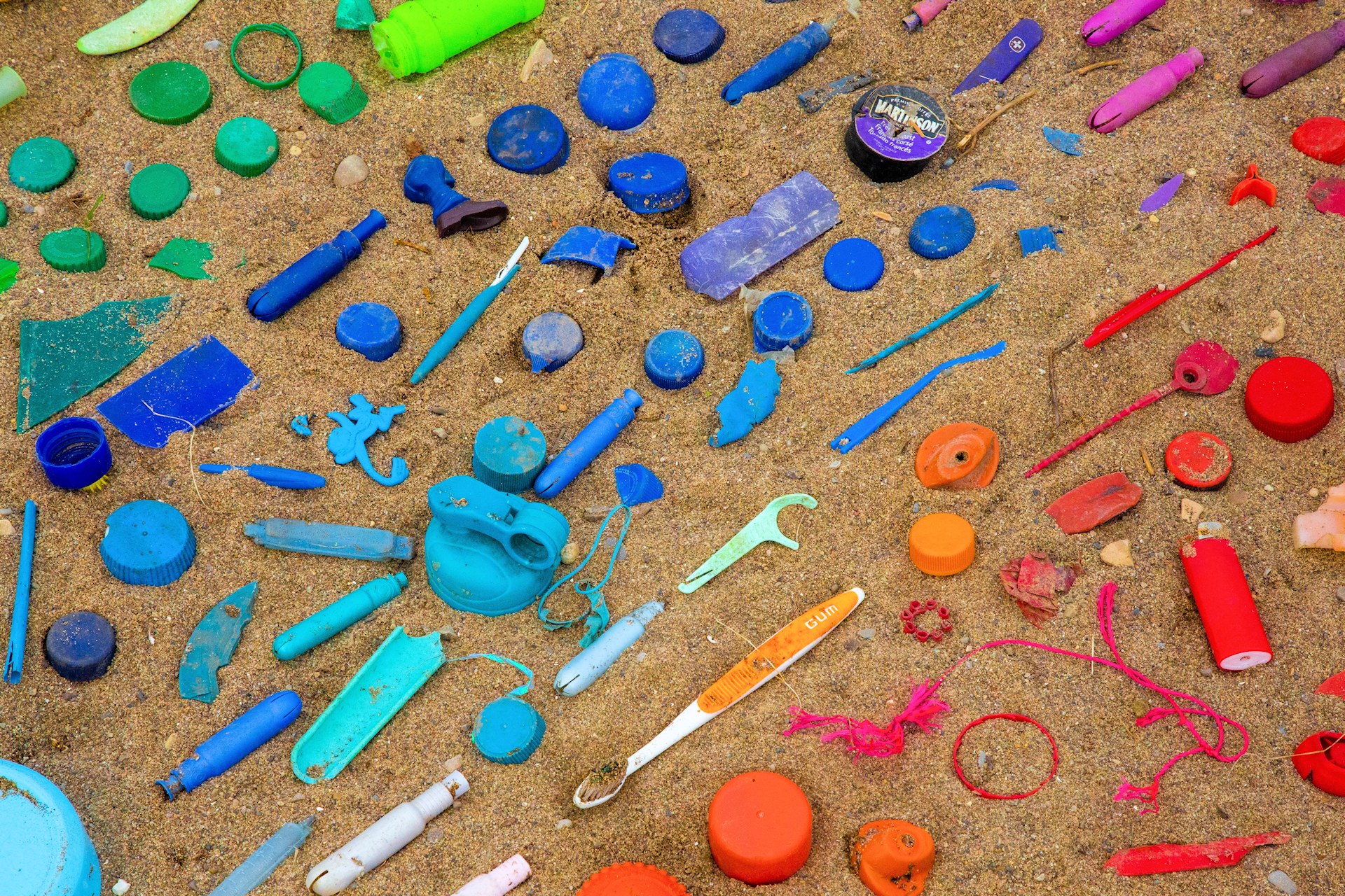 Beach plastic trash sorted by colors